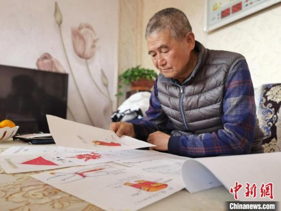 圖為陸鵬飛向記者展示多年帶隊(duì)的手寫筆記?！堟?攝