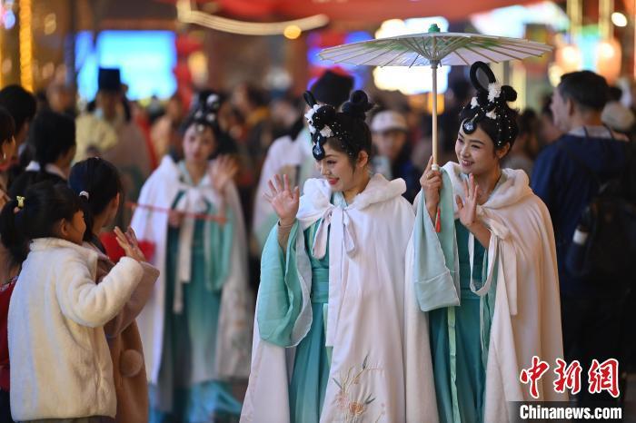 圖為街區(qū)人員著傳統(tǒng)服飾與游人互動(dòng)。李亞龍 攝</p><p>